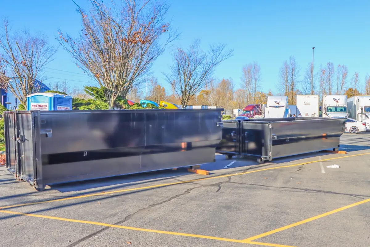 Professional dumpster rental service with roll-off container on residential driveway in Pasadena Hills